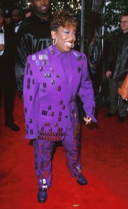 missy elliot in a purple suit with razor blades